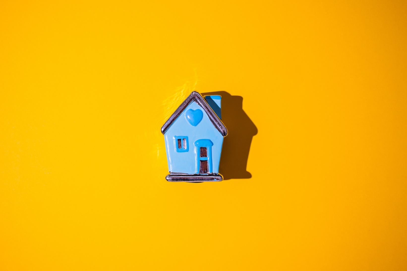 Tiny House Model on Yellow Background